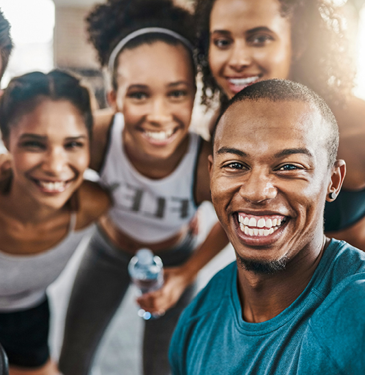 Group of people at fitness center smiling