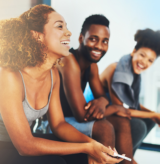 Group of people sitting and talking at fitness center