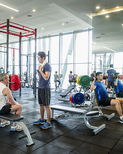 Fitness center interior showing several people on equipment