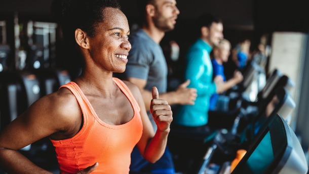 woman running on treadmill at fitness center