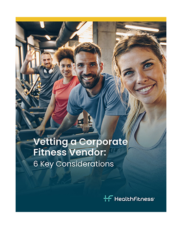 Smiling people on stationary fitness equipment